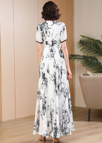 Back view of Vivian Seven monochrome floral maxi dress featuring a high-waisted A-line silhouette and elegant chiffon drape.