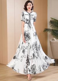 Flowing wide-hem black and white botanical print long dress, vintage-inspired quiet luxury summer fashion by Vivian Seven.