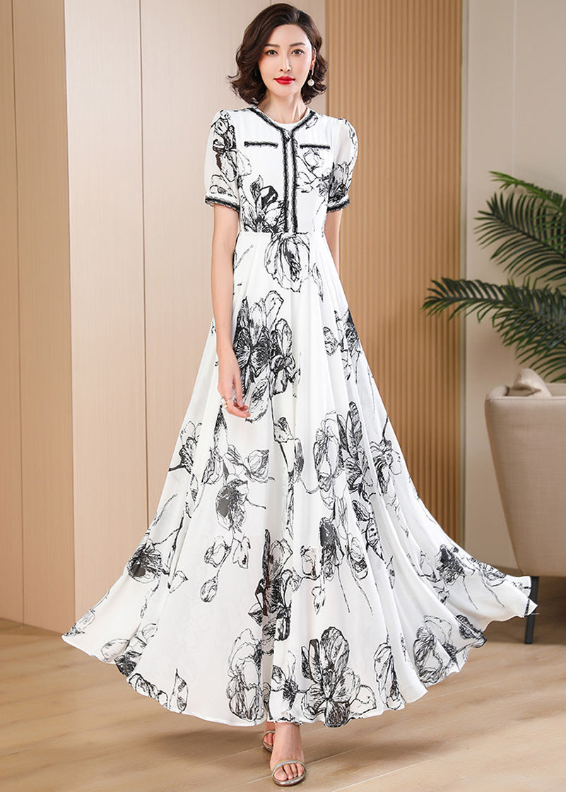 Flowing wide-hem black and white botanical print long dress, vintage-inspired quiet luxury summer fashion by Vivian Seven.