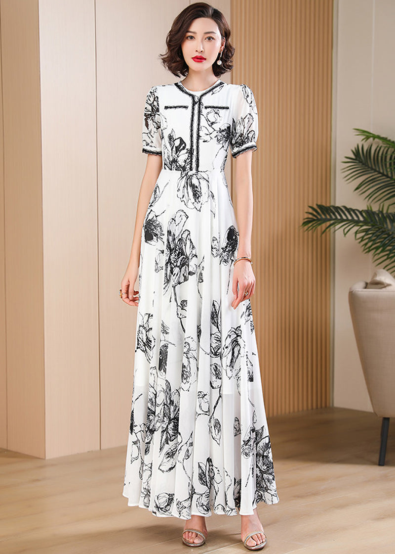 Elegant monochrome floral chiffon maxi dress with puff sleeves and contrast trim, retro-modern style from Vivian Seven.