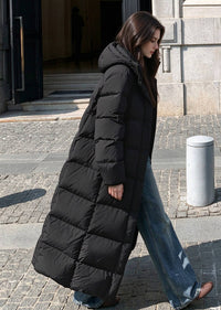 Side view of woman walking outdoors wearing unzipped black 50 inches long duck down puffer coat