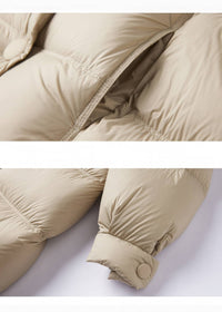 Close-up detail of pocket stitching and cuff button closure on beige down puffer jacket
