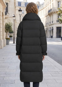 Back view of woman wearing black longline quilted down puffer coat with stand collar