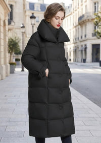 Three-quarter shot of woman wearing black double collar longline down puffer coat with side pockets