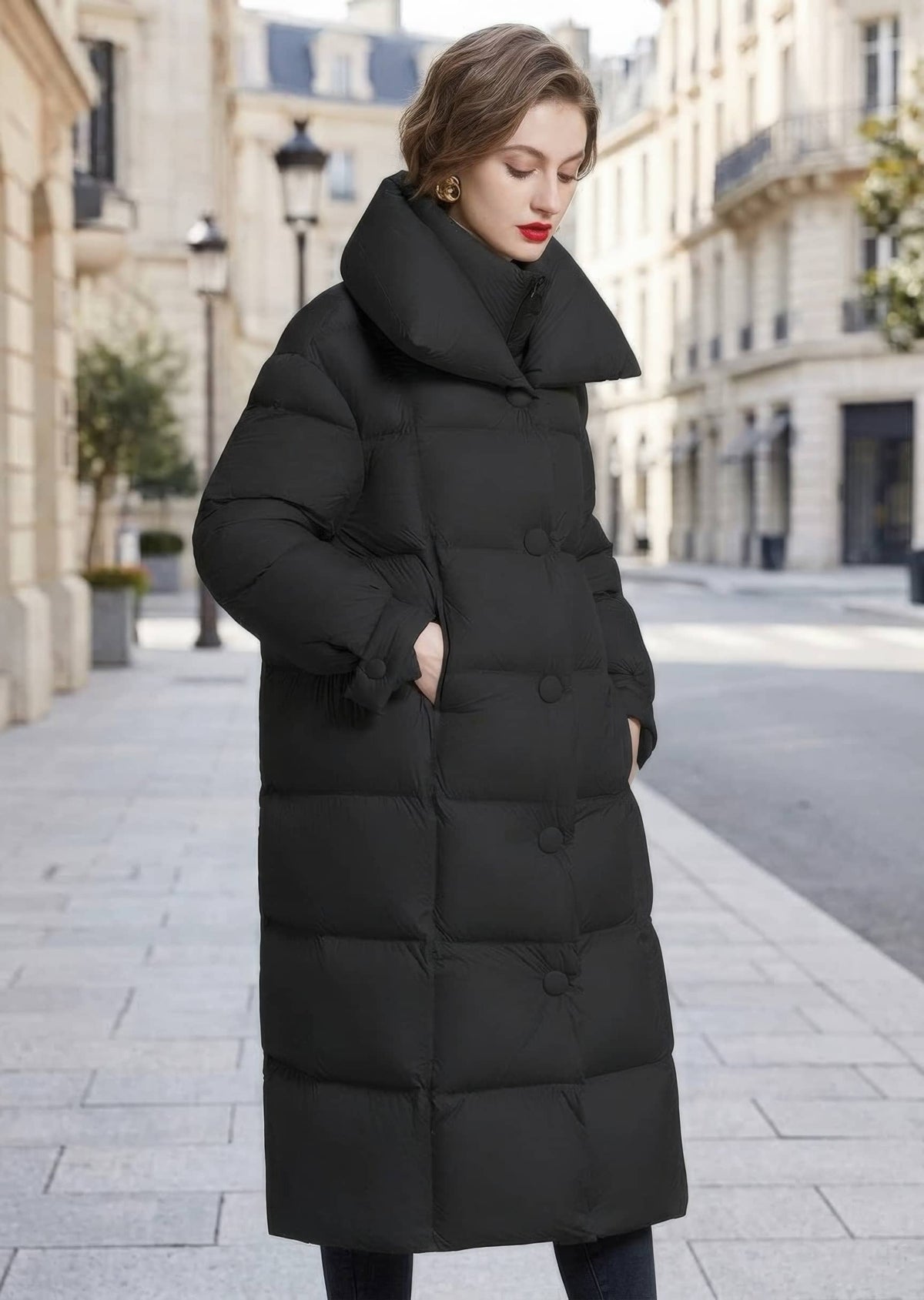 Three-quarter shot of woman wearing black double collar longline down puffer coat with side pockets