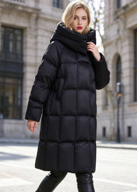 Three-quarter front view of woman wearing black high collar box-quilted long puffer coat