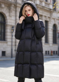 Front view of woman with hood up wearing black high neck quilted down puffer coat