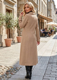 Back side profile view of woman wearing camel classic double-breasted long overcoat with flap pockets