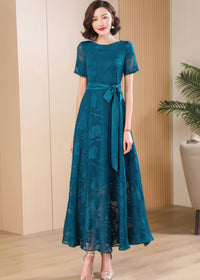 Close-up of the waist and bodice of the Elegant Green Floral Jacquard Maxi Dress, emphasizing the satin bow belt.