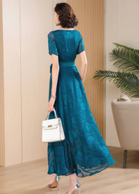 Back view of the Elegant Green Floral Jacquard Maxi Dress showing the flowing A-line silhouette and short sleeves.