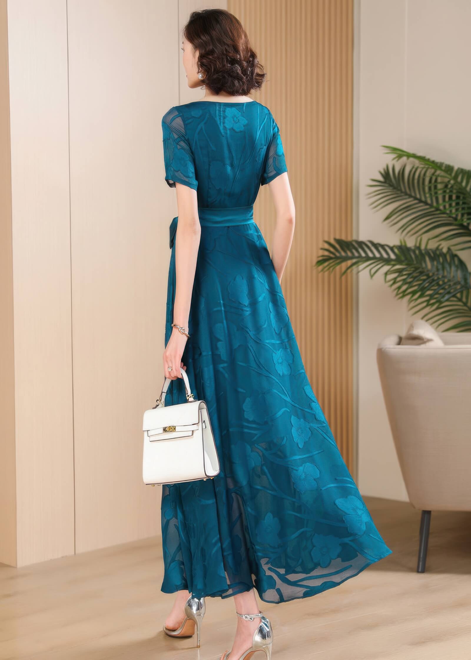 Back view of the Elegant Green Floral Jacquard Maxi Dress showing the flowing A-line silhouette and short sleeves.