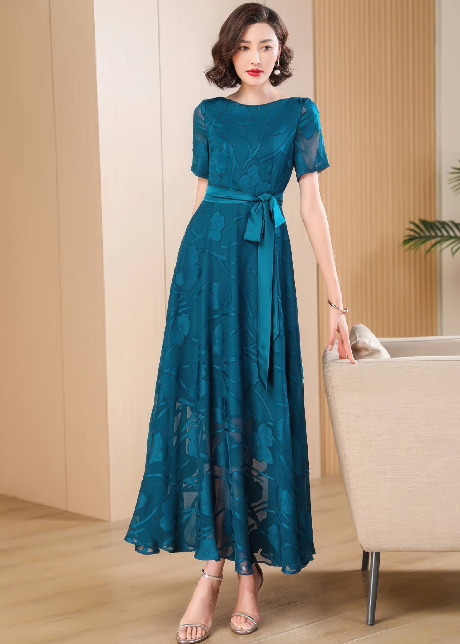 Close-up of the Elegant Green Floral Jacquard Maxi Dress featuring the boat neckline and intricate floral burnout texture.