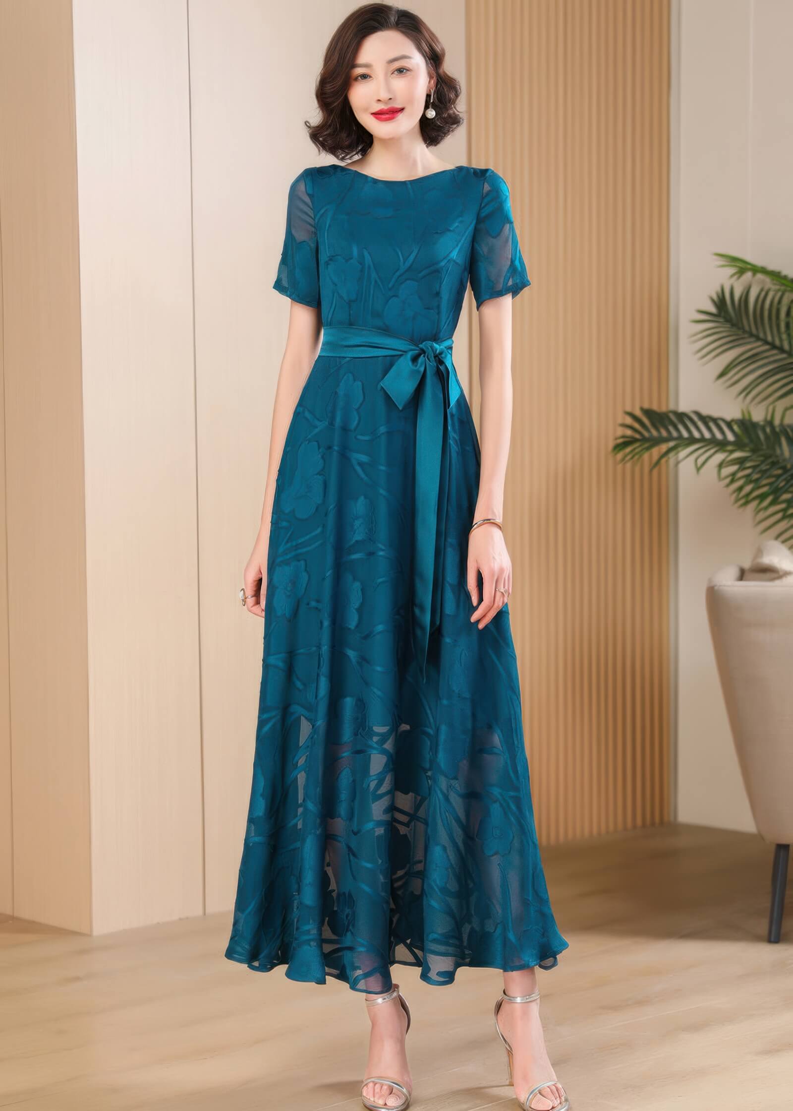 Frontal view of the Elegant Green Floral Jacquard Maxi Dress, highlighting the elegant drape of the fabric.