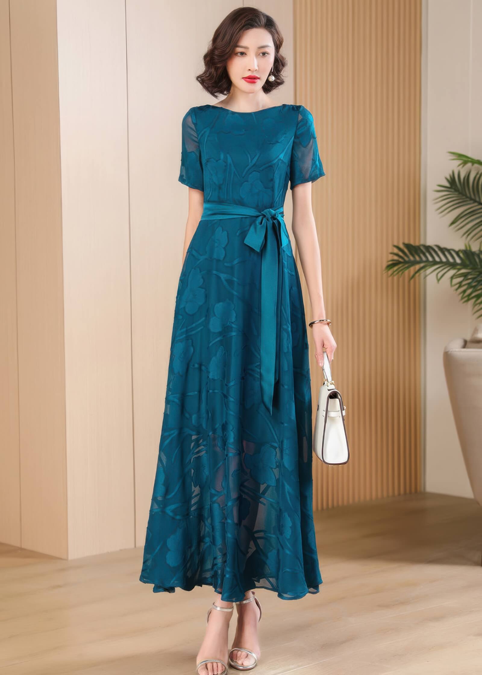 Side-profile view of the Elegant Green Floral Jacquard Maxi Dress with focus on the subtle sheer texture of the sleeves.