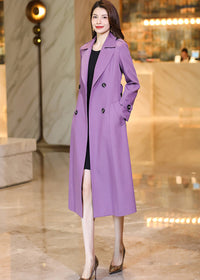 A Vivian Seven purple long trench coat worn open over a black dress, showcasing a versatile layered look.
