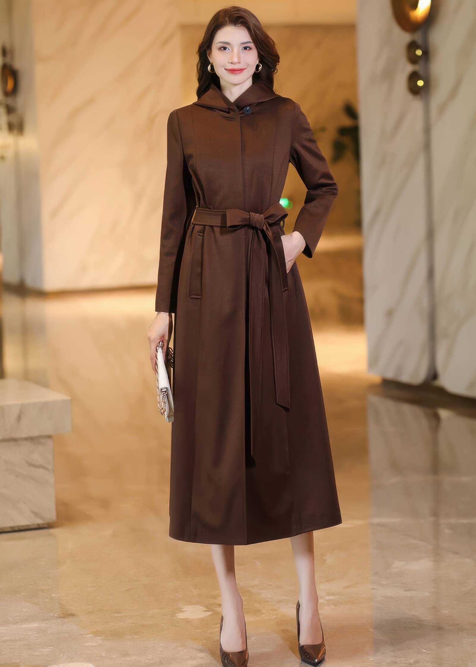 Elegant front view of a fastened chocolate brown hooded trench coat with a structured waist belt and classic lapels.