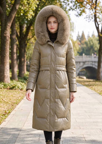 Full length front view of woman wearing khaki genuine sheepskin leather down coat with hood up in park setting