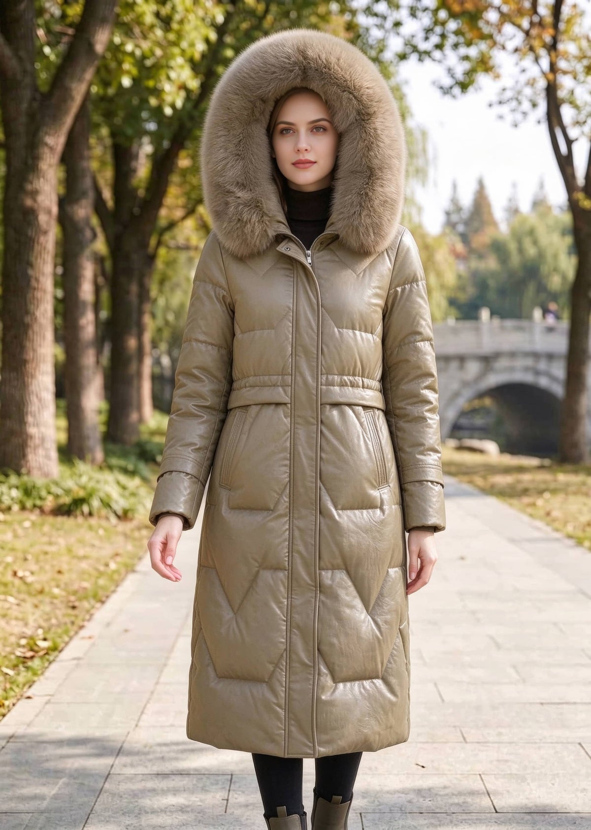 Full length front view of woman wearing khaki genuine sheepskin leather down coat with hood up in park setting