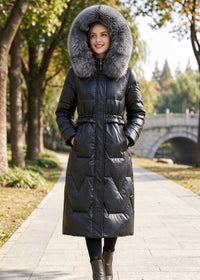 Full length front view of smiling woman wearing black genuine sheepskin leather down coat with fluffy fox fur trim hood