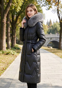 Three-quarter side portrait of woman wearing black genuine sheepskin leather down long coat with real fox fur collar