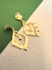 Back view of the gold earrings showing the post-back closures and transparent plastic disc backings for secure wear.