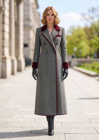 Full length front view of woman wearing grey herringbone double-breasted long coat with burgundy velvet collar and cuffs
