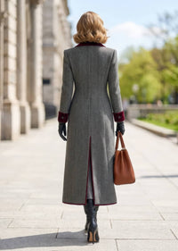 Back view of woman walking outdoors in grey ribbed turtleneck fitted sweater dress with belted waist
