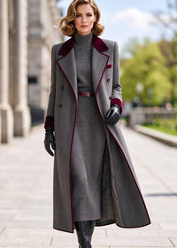 Three-quarter shot of woman wearing open grey herringbone double-breasted coat layered over ribbed sweater dress