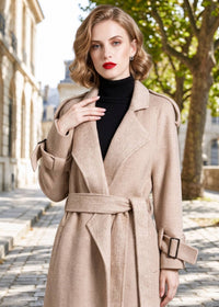 Close-up portrait of woman wearing beige herringbone double face wool cashmere coat with belted waist