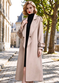 Three-quarter view of woman wearing unzipped beige herringbone double face wool wrap coat
