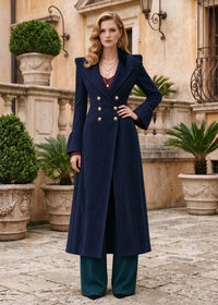 Full length front view of woman posing with hand on hip wearing navy blue corduroy fit and flare long coat