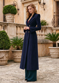 Three-quarter side profile view of woman wearing navy blue fit and flare corduroy long coat outdoors