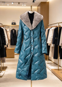 Teal blue quilted genuine sheepskin leather down coat with plush mink fur shawl collar displayed on mannequin in store
