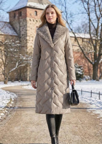 Full length front view of woman holding handbag wearing taupe quilted genuine sheepskin leather down coat with mink fur collar