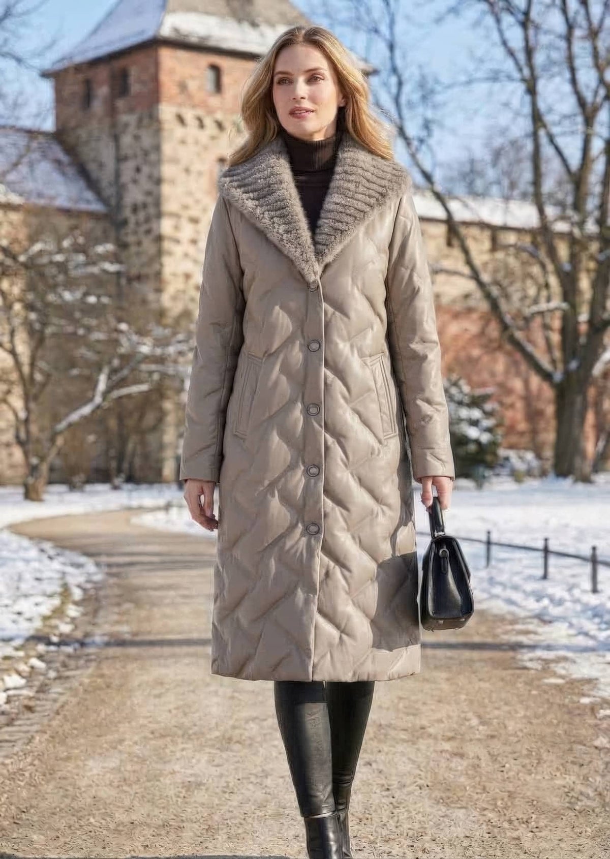 Full length front view of woman holding handbag wearing taupe quilted genuine sheepskin leather down coat with mink fur collar