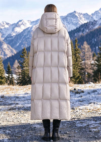 Back view of woman wearing beige quilted longline hooded down parka coat