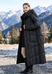 Side view of woman wearing unzipped black longline down parka coat with hood