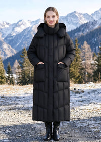 Full length front view of woman with hands in pockets wearing black longline hooded down parka