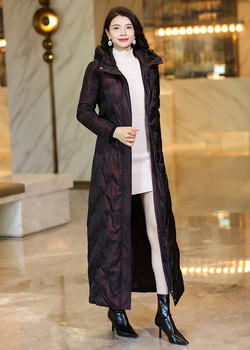 Model wearing an open deep wine shimmering maxi down parka showing an elegant inner sweater layer