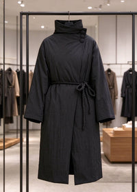 Black asymmetric high neck longline down coat with rope belt on display rack