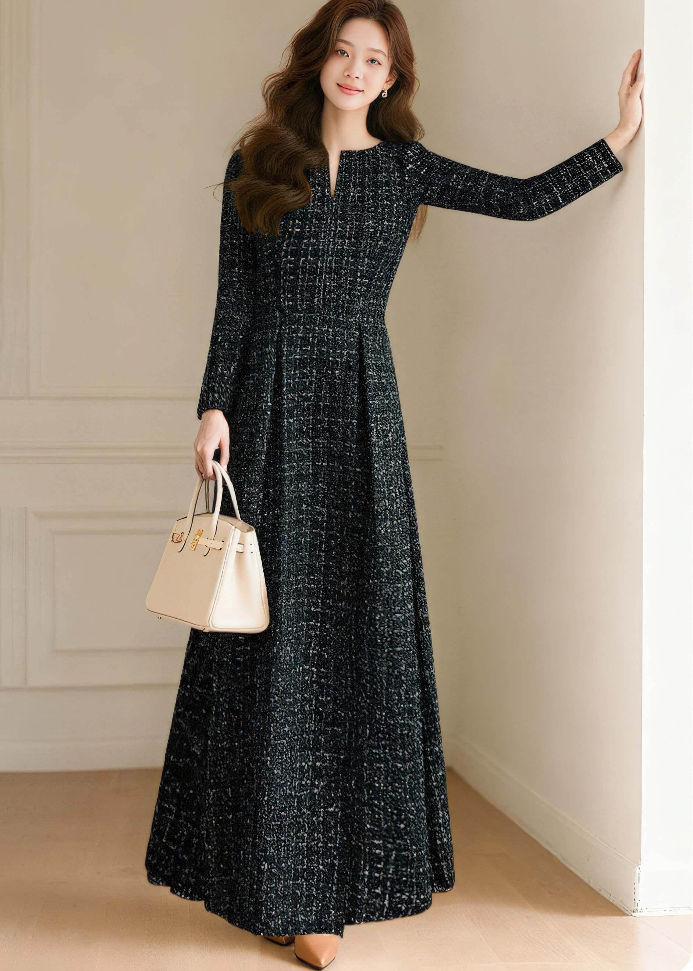 Side profile of the black tweed maxi dress by Vivian Seven, highlighting the tailored fit and flowing ankle-length hem.