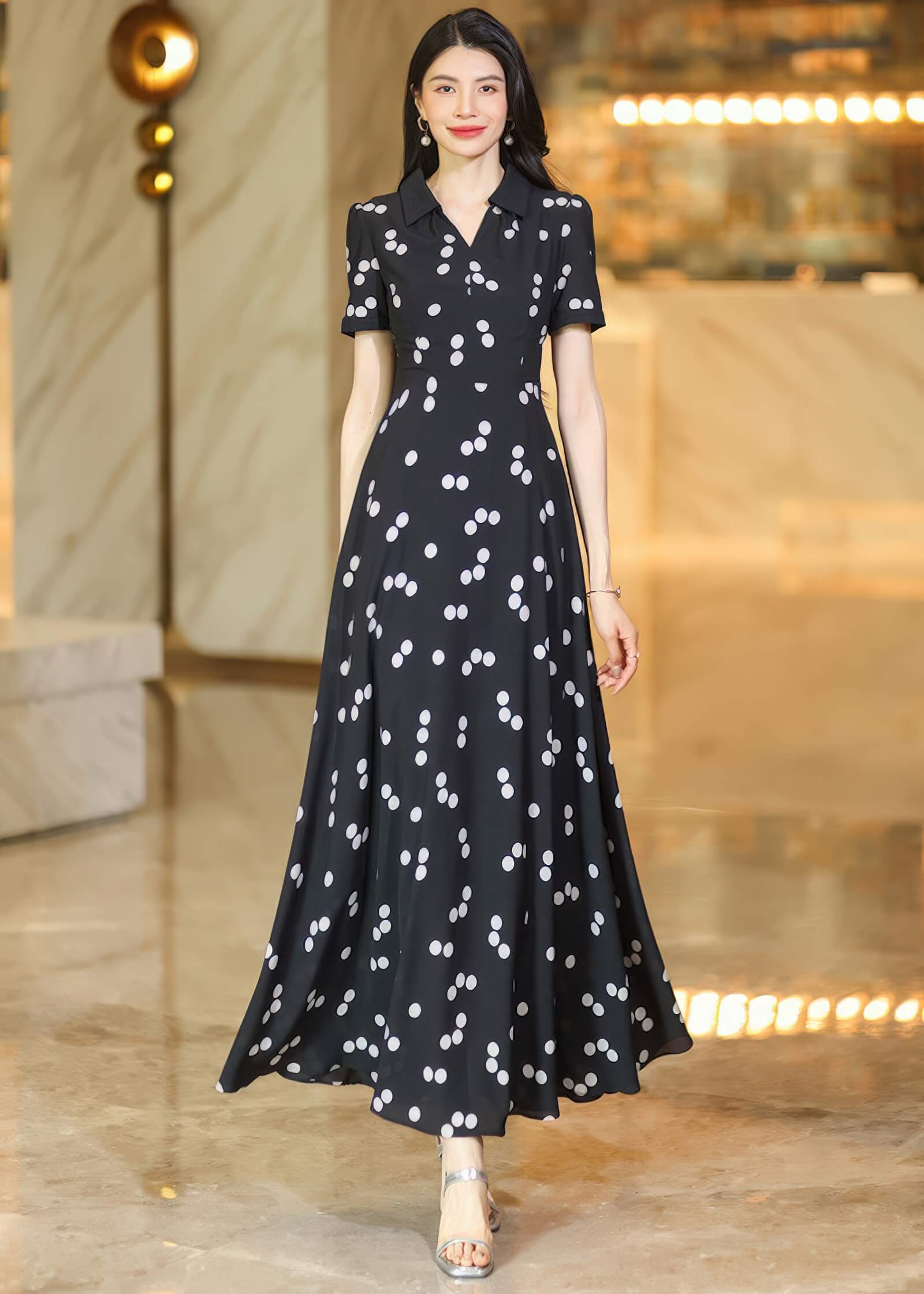 A stylish shot of a woman in a long-sleeved polka dot maxi dress, showcasing the button-down front and cinched waist."