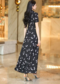 Back view of a chic black and white polka dot dress with a structured collar, ideal for formal or smart-casual wear."