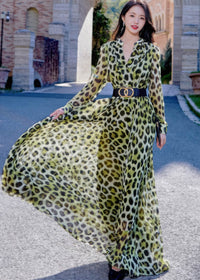 Front view of the leopard print long-sleeve maxi dress, featuring a flattering V-neckline and a black statement belt with gold double-ring hardware.