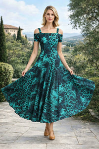 Front view of a woman holding out both sides of a flowing emerald green and black leopard print off-the-shoulder A-line maxi dress, displaying the full flare of the skirt.