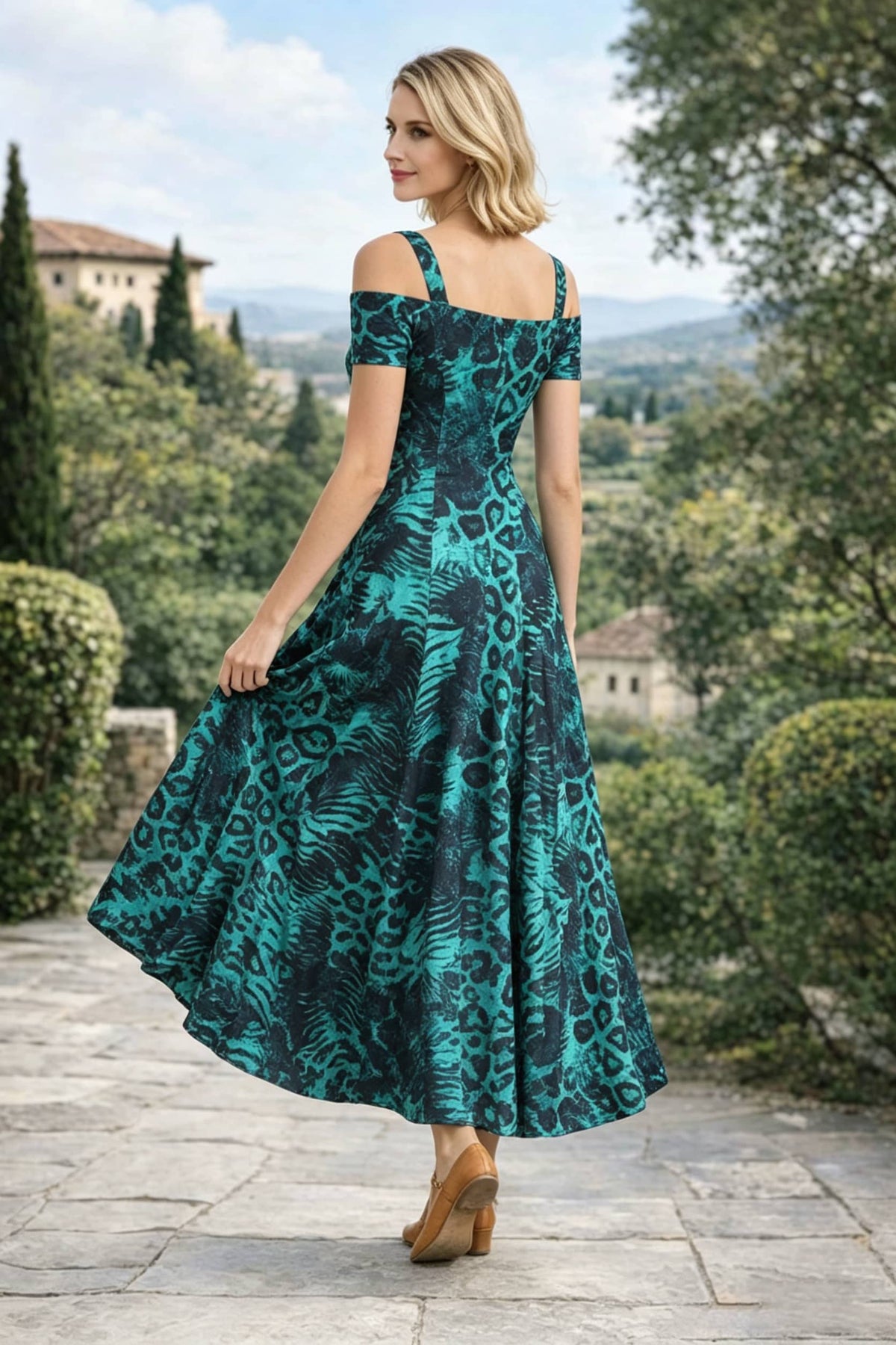 Three-quarter back view of a woman looking over her shoulder, highlighting the back design and fit of an emerald green and black leopard print off-the-shoulder A-line maxi dress.