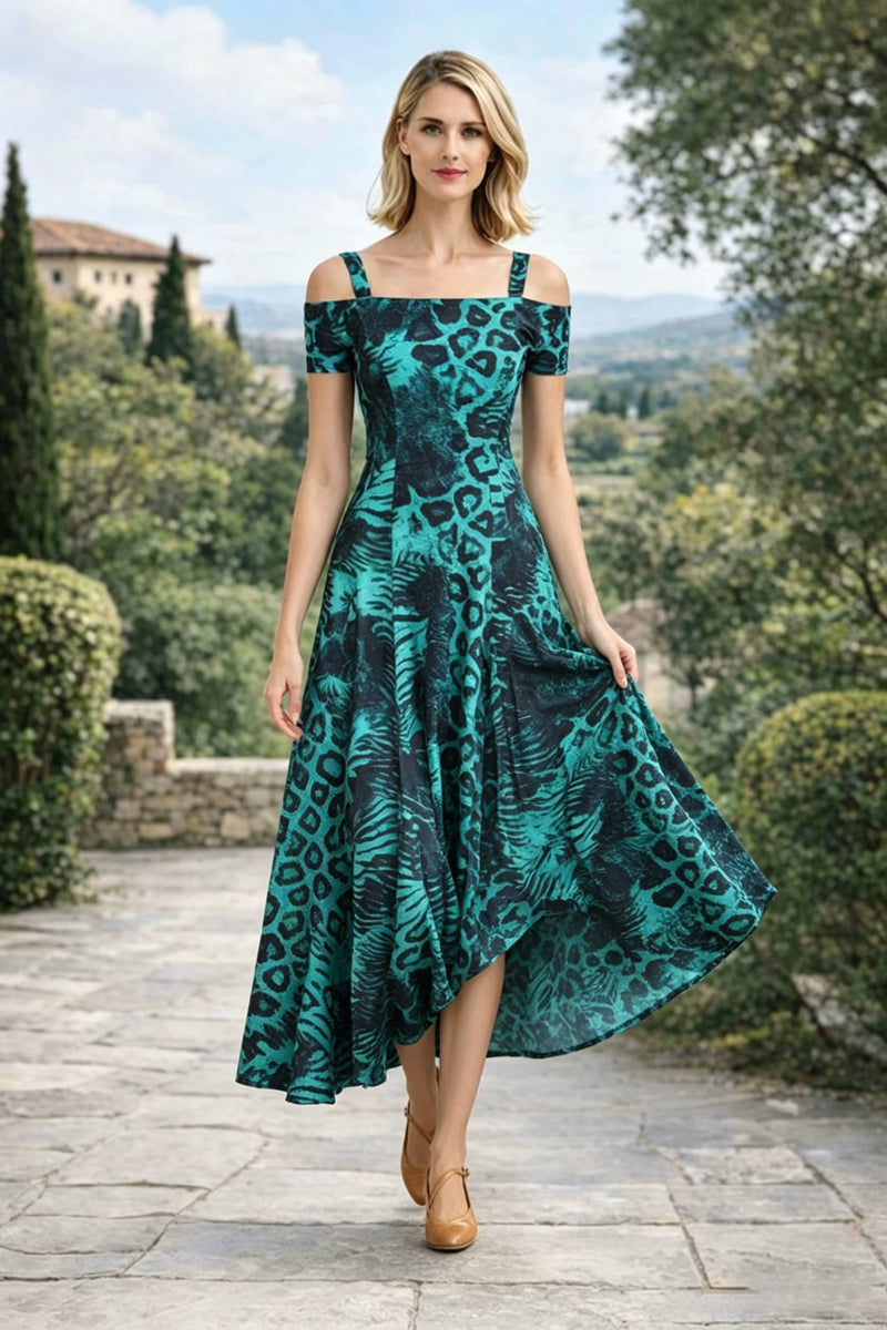 A woman mid-stride, lifting the front hem of an emerald green and black leopard print off-the-shoulder A-line maxi dress to reveal her leg and tan mary-jane style heels.