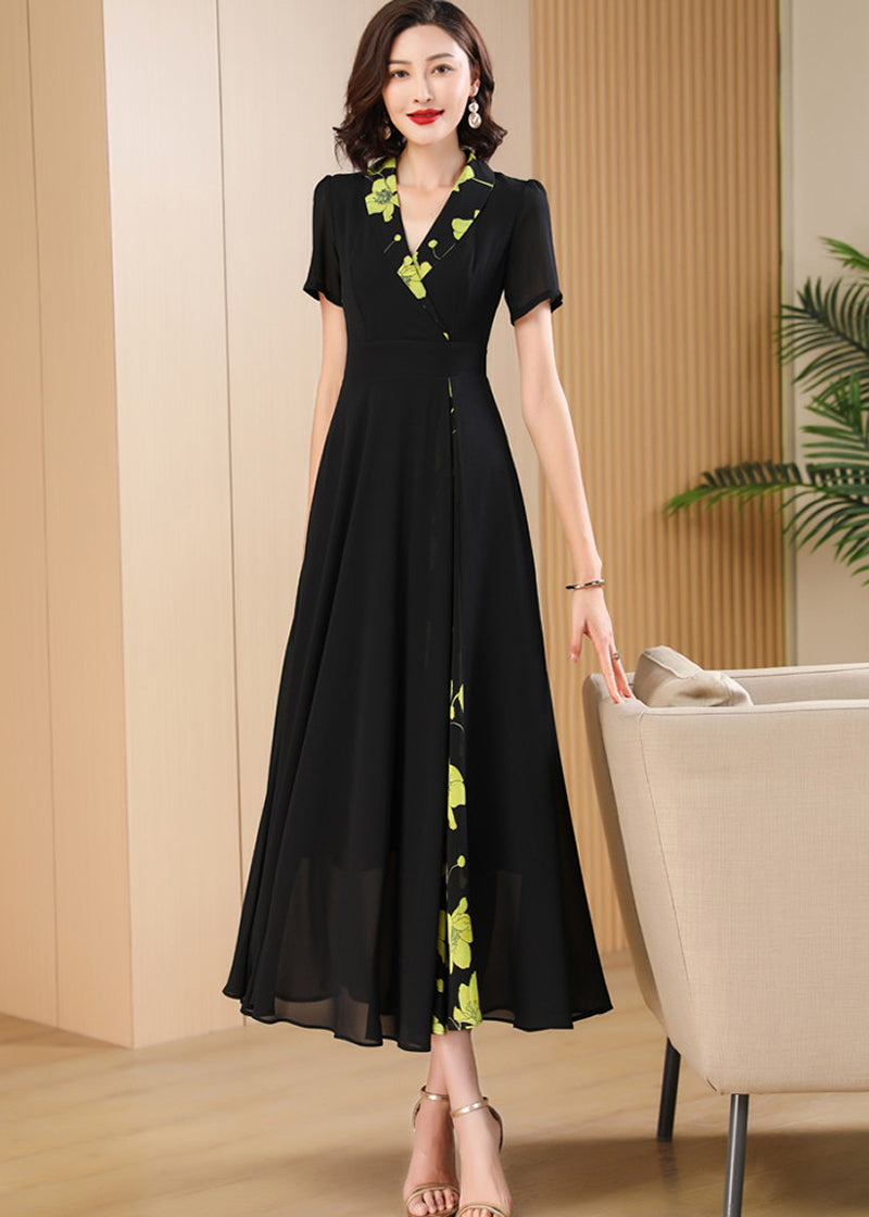 Standing Pose,Sophisticated black maxi dress for women featuring a wrap-style V-neckline and vibrant yellow-green floral accents.
