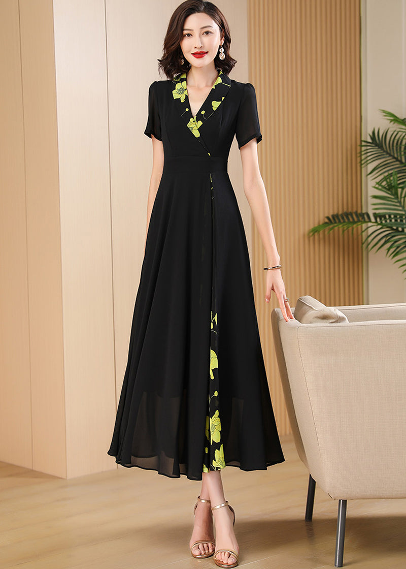 Standing Pose,Sophisticated black maxi dress for women featuring a wrap-style V-neckline and vibrant yellow-green floral accents.