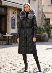 Full length front view of woman wearing black Vivian Seven genuine leather puffer long down parka with fluffy fur hood